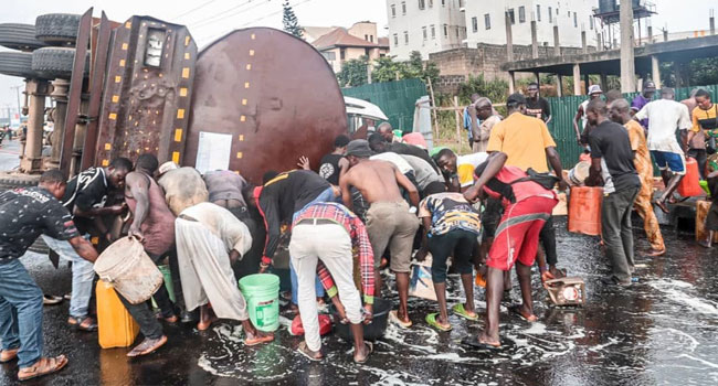 Residents scoop fuel as tanker overturns